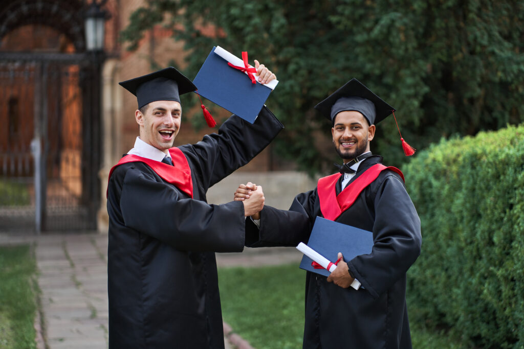 two international graduate celebrating graduation in university